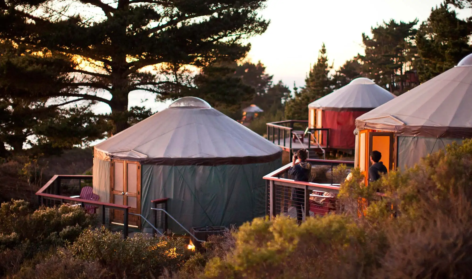 Yurts at Treebones Resort, golden hour above the Pacific — the built-out resort