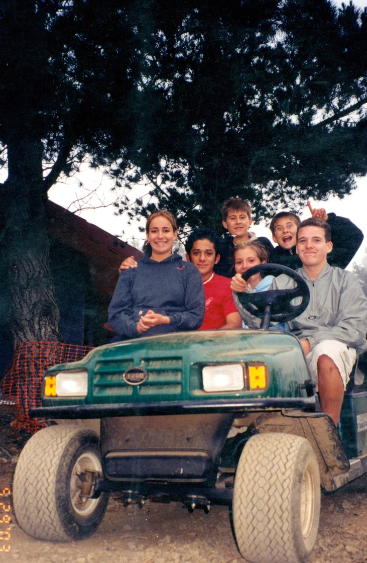 The Handy kids and friends on a golf cart at Treebones, May 2003
